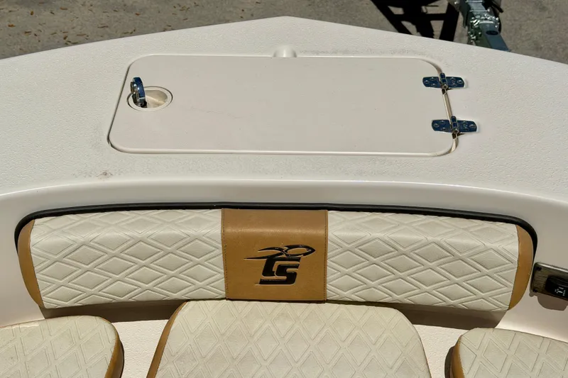 Slide: The Image of 2026 Carolina Skiff 24 Ultra Elite boat seat with diamond-pattern upholstery and storage hatch. - 21