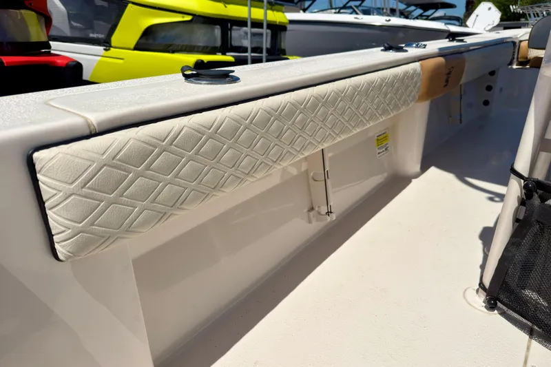 Slide: The Image of 2026 Carolina Skiff 24 Ultra Elite boat interior with cushioned side panel detail. - 23