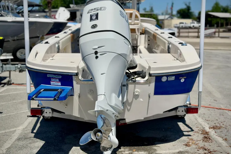Slide: The Image of 2026 Carolina Skiff 24 Ultra Elite boat with powerful outboard motor, parked on trailer. - 25