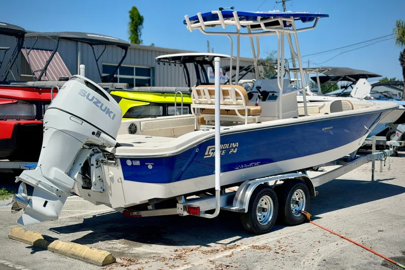 Slide: The Image of 2026 Carolina Skiff 24 Ultra Elite boat with Suzuki outboard motor on trailer. - 29