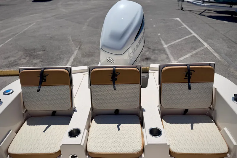 Slide: The Image of 2026 Carolina Skiff 24 Ultra Elite boat seats with diamond-pattern upholstery and cup holders. - 3