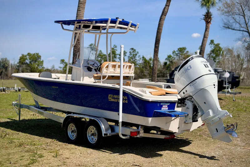 Slide: The Image of 2026 Carolina Skiff 24 Ultra Elite boat with Suzuki outboard motor on trailer. - 30