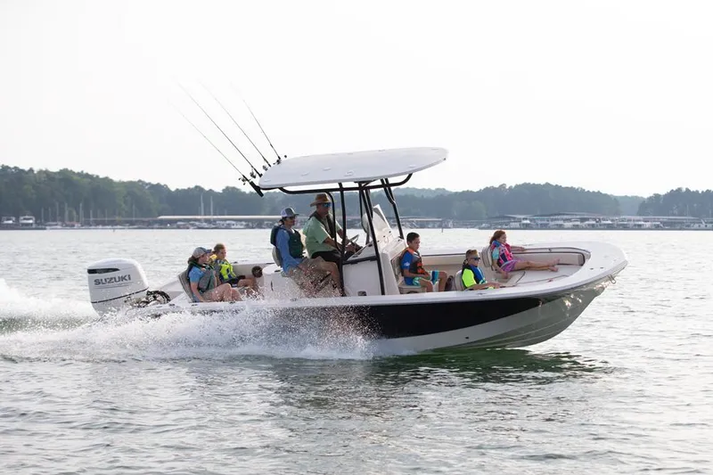 Slide: The Image of Manufacturer Provided Image: 2026 Carolina Skiff 24 Ultra Elite boat cruising with passengers on a lake. - 32