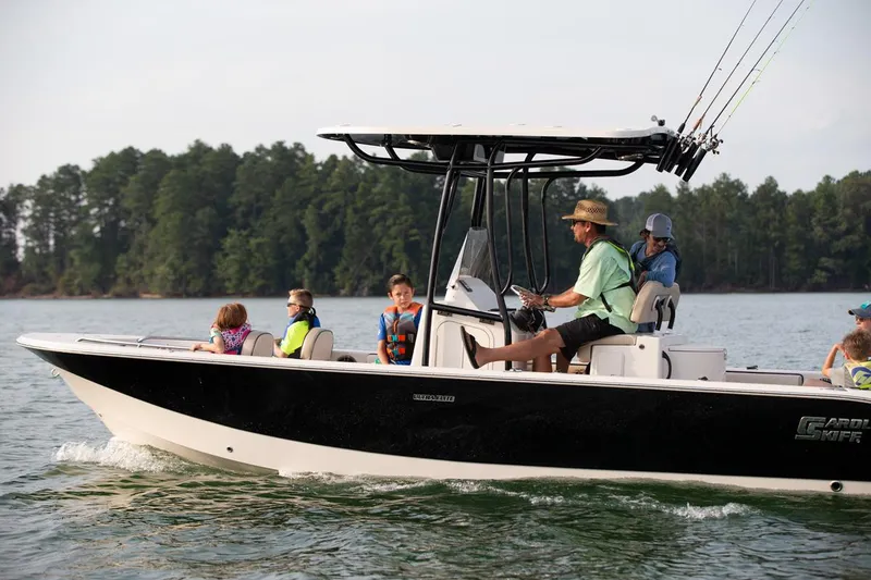 Slide: The Image of Manufacturer Provided Image: 2026 Carolina Skiff 24 Ultra Elite boat cruising with passengers on a scenic lake. - 36