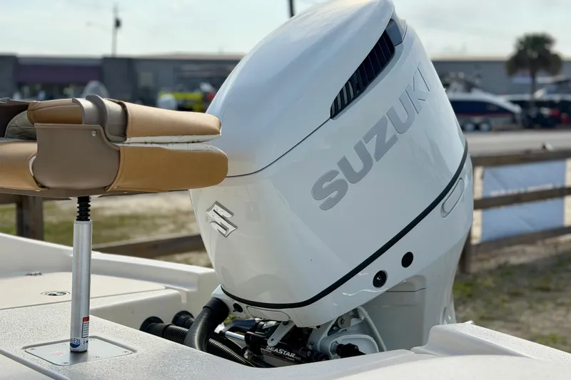Slide: The Image of 2026 Carolina Skiff 24 Ultra Elite with Suzuki outboard motor, docked outdoors. - 5