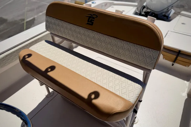 Slide: The Image of 2026 Carolina Skiff 24 Ultra Elite boat seat with tan and white diamond pattern upholstery. - 6