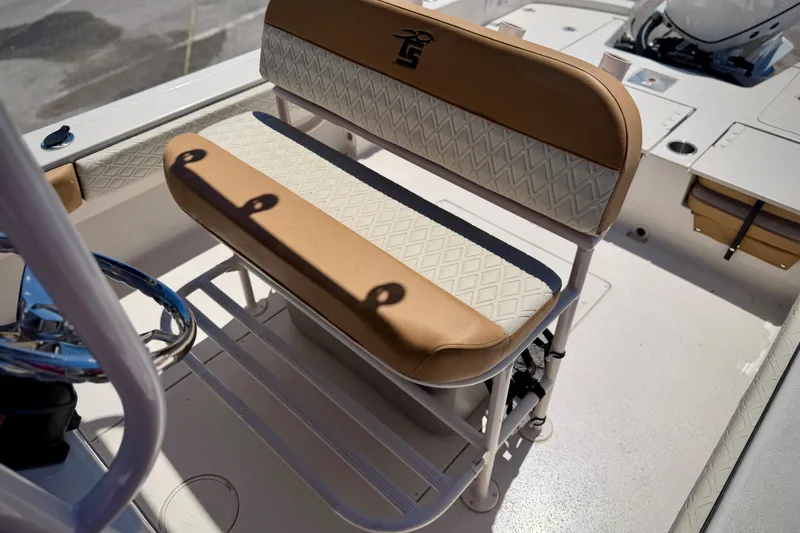 Slide: The Image of 2026 Carolina Skiff 24 Ultra Elite boat interior with tan and white seating. - 7
