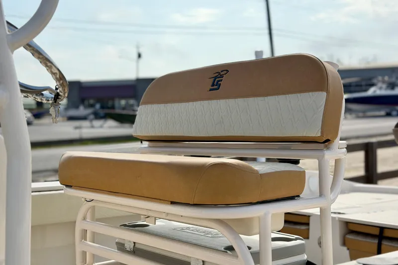 Slide: The Image of 2026 Carolina Skiff 24 Ultra Elite boat seat with tan and white upholstery. - 8