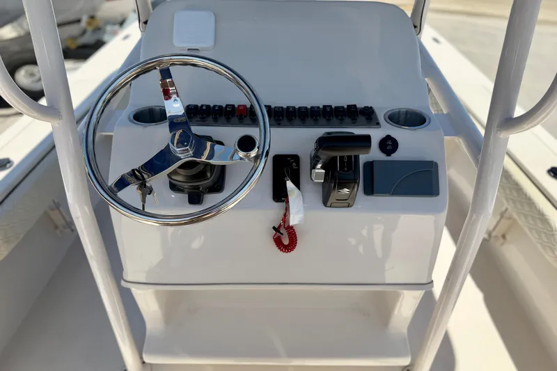 Slide: The Image of Steering console of 2026 Carolina Skiff 24 Ultra Elite boat with controls and switches. - 9