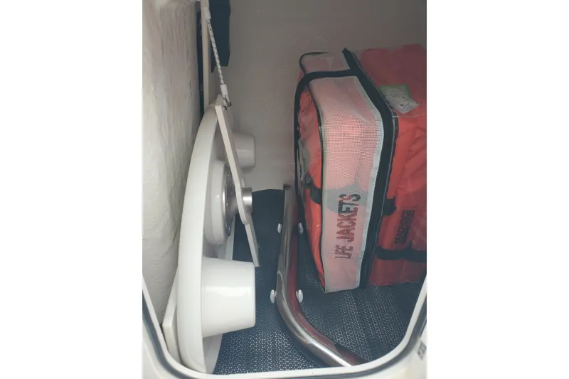 Slide: The Image of Storage compartment in 2026 Chaparral 23 SSi boat with life jackets and equipment. - 11