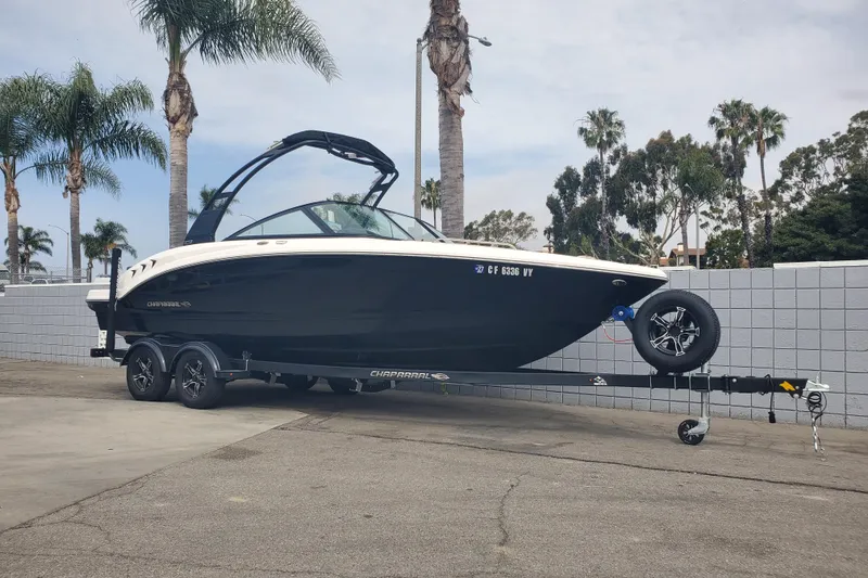 Slide: The Image of 2026 Chaparral 23 SSi boat on trailer, parked near palm trees. - 15