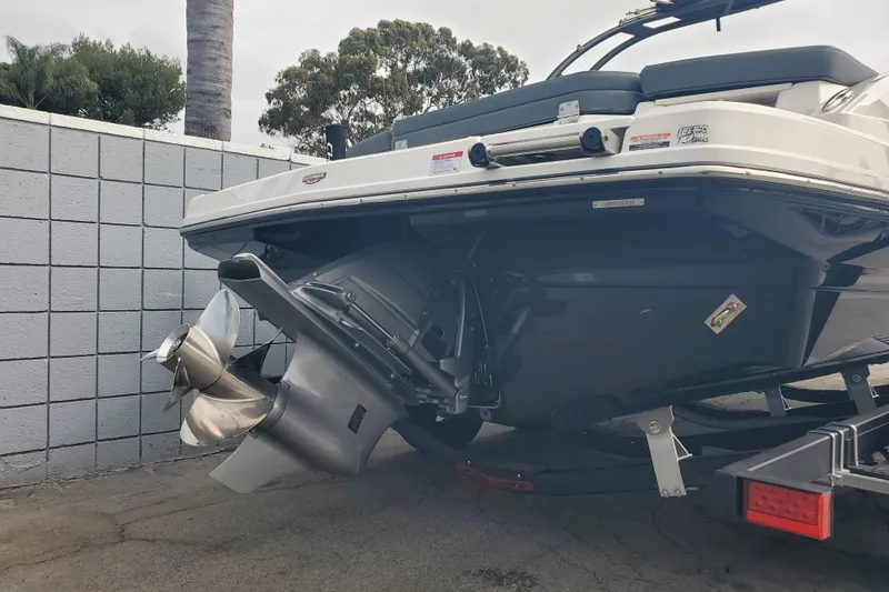 Slide: The Image of Rear view of a 2026 Chaparral 23 SSi boat on a trailer, showcasing the propeller. - 16