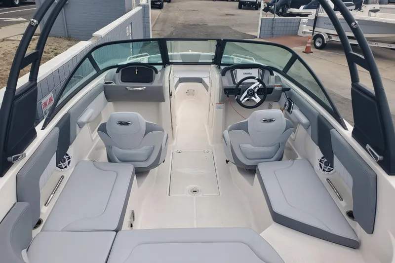 Slide: The Image of 2026 Chaparral 23 SSi boat interior with sleek gray seating and modern dashboard. - 4