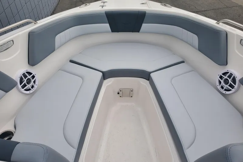 Slide: The Image of Interior view of 2026 Chaparral 23 SSi boat with cushioned seating and speakers. - 6