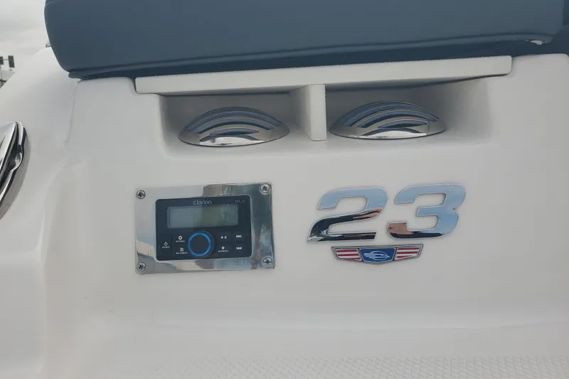 Slide: The Image of 2026 Chaparral 23 SSi boat dashboard with Clarion audio system and model emblem. - 8