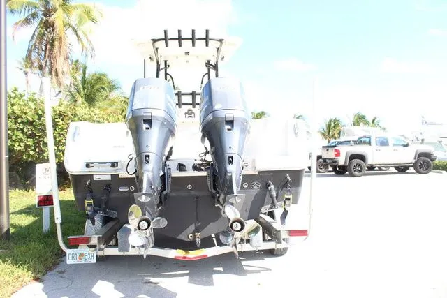 Slide: The Image of Rear view of a 2015 Sailfish 240 CC with dual outboard motors. - 11