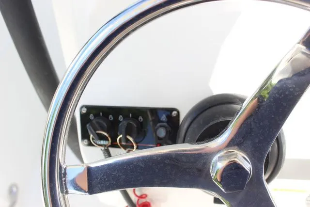 Slide: The Image of Steering wheel and control panel of a 2015 Sailfish 240 CC boat. - 20