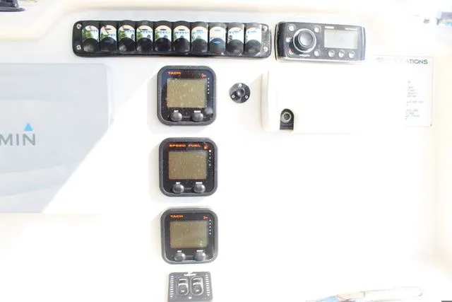 Slide: The Image of Dashboard of a 2015 Sailfish 240 CC with instruments and controls. - 22