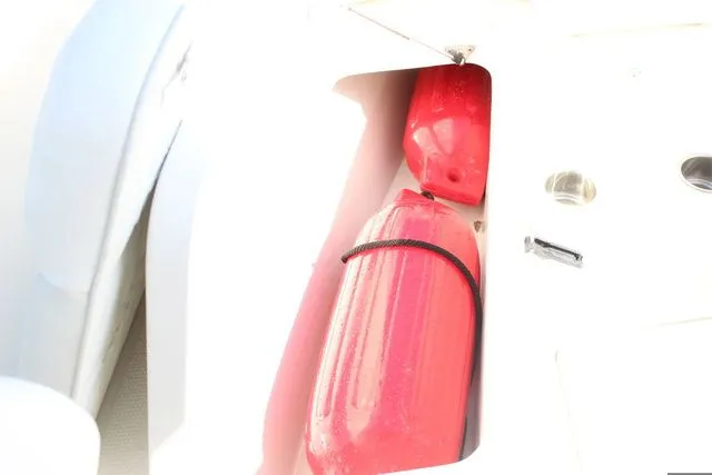 Slide: The Image of Red fenders in storage compartment of a 2015 Sailfish 240 CC boat. - 31