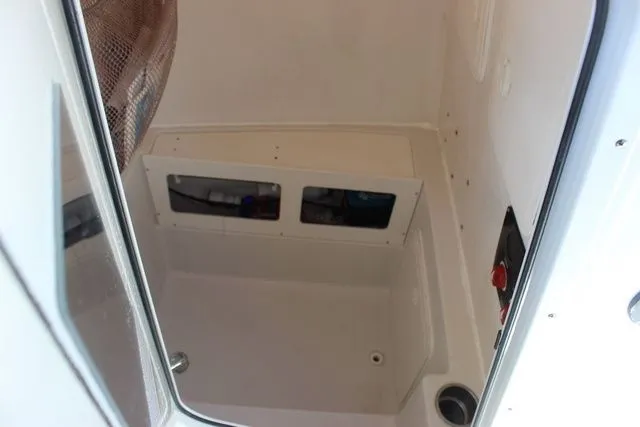 Slide: The Image of Interior of 2015 Sailfish 240 CC with storage and controls. - 36