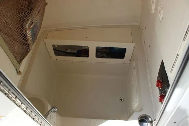 Slide: The Image of Interior of 2015 Sailfish 240 CC with storage and controls. - 38