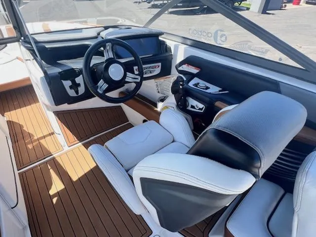 Slide: The Image of Interior of a 2017 Nautique G25 boat with modern helm station. - 11