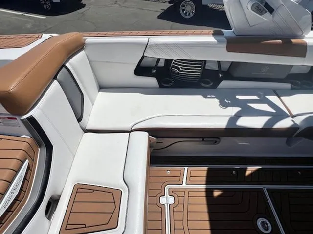 Slide: The Image of Interior of a 2017 Nautique G25 boat with brown and white seating. - 13
