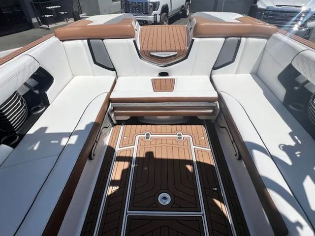 Slide: The Image of Interior of a 2017 Nautique G25 boat with brown and white seating. - 14
