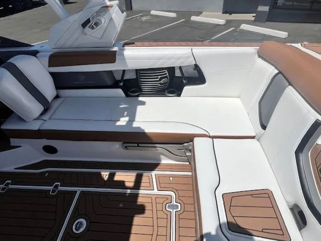 Slide: The Image of Interior of a 2017 Nautique G25 boat with white and brown seating. - 15