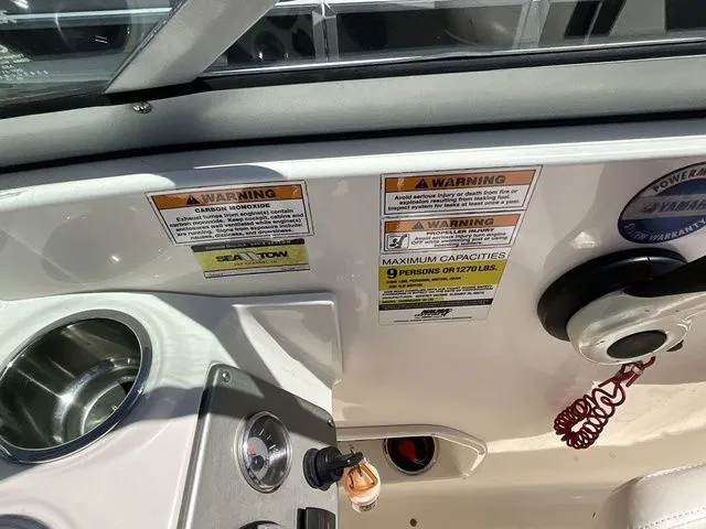 Slide: The Image of Interior view of a 2013 Stingray 208 LR boat with warning labels. - 15
