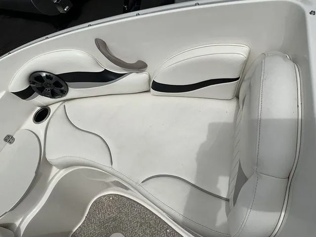 Slide: The Image of Interior of a 2013 Stingray 208 LR boat with white upholstery. - 17