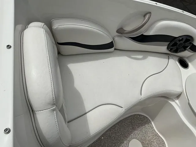 Slide: The Image of Interior of a 2013 Stingray 208 LR boat with white upholstery. - 18