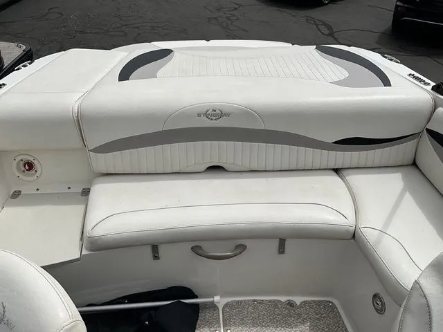 Slide: The Image of Interior of a 2013 Stingray 208 LR boat with white seating. - 19