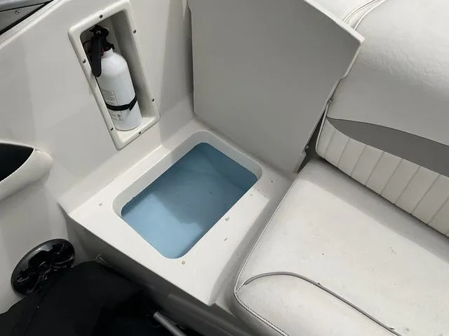 Slide: The Image of Interior of 2013 Stingray 208 LR with storage compartment and fire extinguisher. - 20