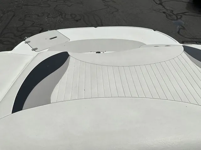 Slide: The Image of Rear view of 2013 Stingray 208 LR boat with cushioned seating area. - 21