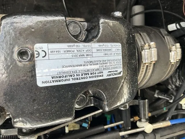 Slide: The Image of Close-up of a Mercury engine in a 2013 Stingray 208 LR boat. - 23