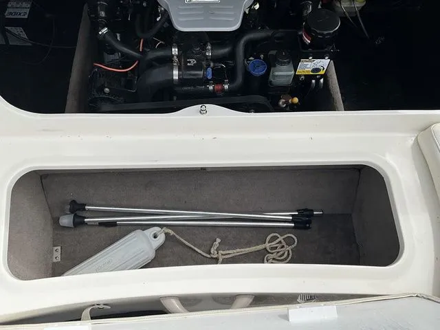 Slide: The Image of Engine compartment of 2013 Stingray 208 LR with storage area. - 24