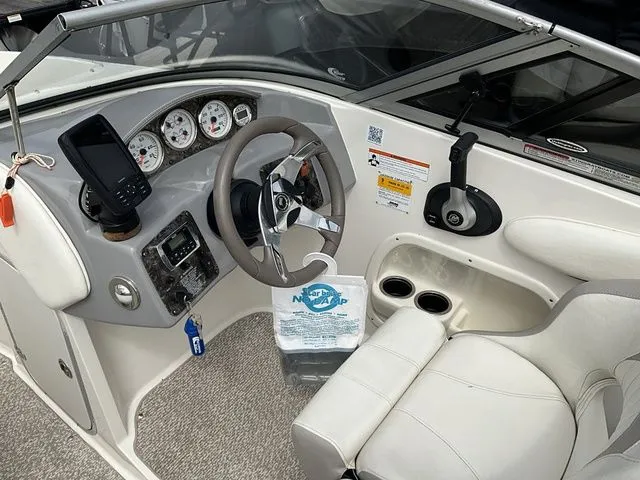 Slide: The Image of Interior of a 2013 Stingray 208 LR boat with steering console. - 26