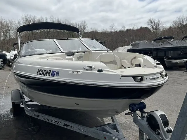 Slide: The Image of 2013 Stingray 208 LR boat parked on trailer outdoors. - 3