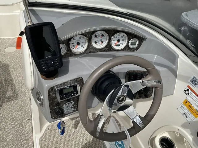 Slide: The Image of Dashboard of a 2013 Stingray 208 LR boat with steering wheel and gauges. - 30