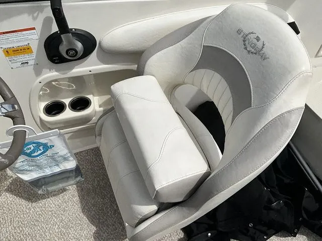 Slide: The Image of Interior of a 2013 Stingray 208 LR boat with beige seating. - 31