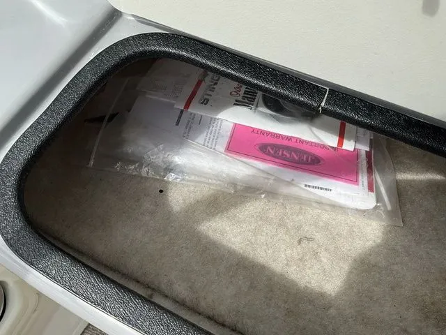 Slide: The Image of Stingray 208 LR 2013 boat documents in storage compartment. - 32