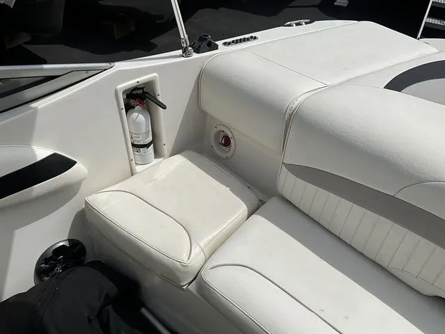 Slide: The Image of Interior of a 2013 Stingray 208 LR boat with white seating area. - 36