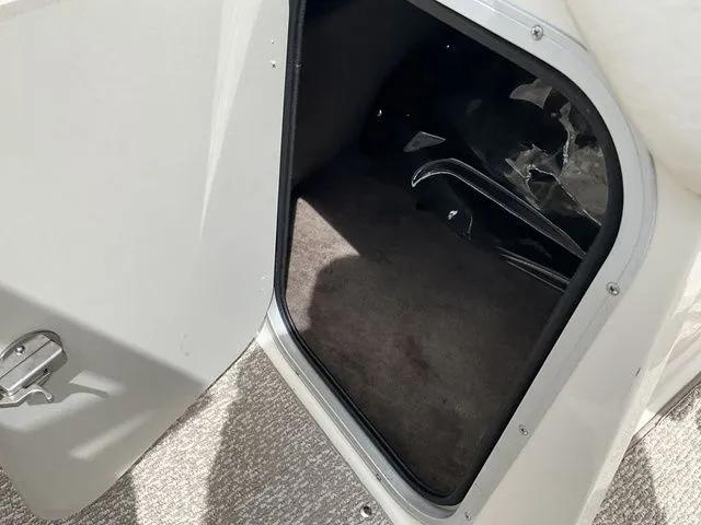 Slide: The Image of Open storage compartment in 2013 Stingray 208 LR boat. - 37