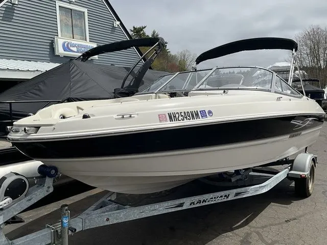 Slide: The Image of 2013 Stingray 208 LR boat on trailer in front of building. - 4