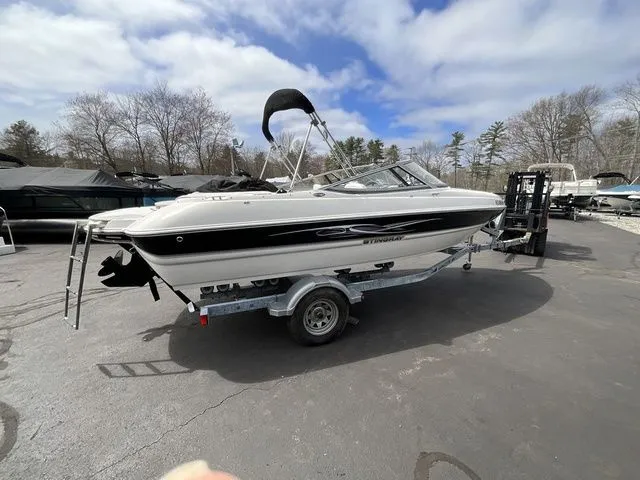 Slide: The Image of 2013 Stingray 208 LR boat parked on trailer outdoors. - 40