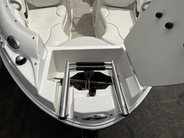 Slide: The Image of 2013 Stingray 208 LR boat with built-in ladder and seating area. - 8
