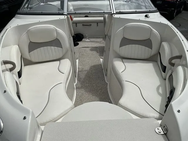 Slide: The Image of Interior of a 2013 Stingray 208 LR boat with white seating. - 9