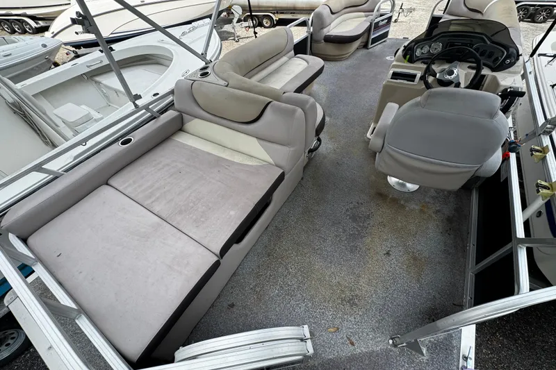 Slide: The Image of 2015 Sun Tracker Party Barge 22 DLX interior with seating and helm. - 6