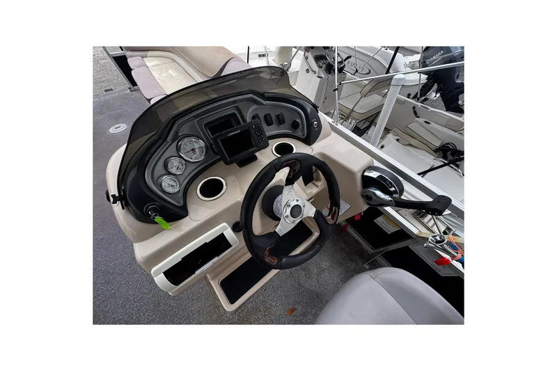 Slide: The Image of 2015 Sun Tracker Party Barge 22 DLX helm with steering wheel and control panel. - 7